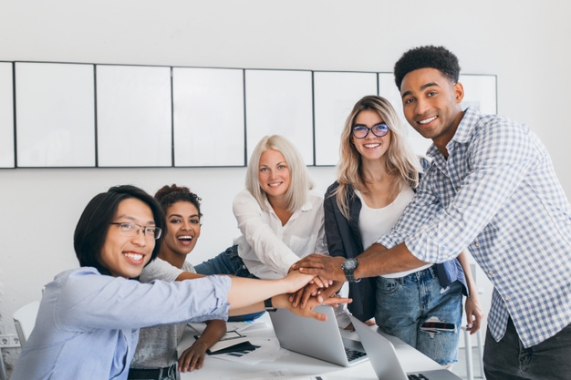 charming-blonde-employee-having-fun-with-colleagues-posing-photo-light-room-team-it-specialists-ended-big-hard-business-project-shaking-hands_197531-3738